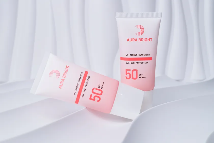 ภาพ Packshot หลอดครีมกันแดด AURA BRIGHT บนฉากสีขาว